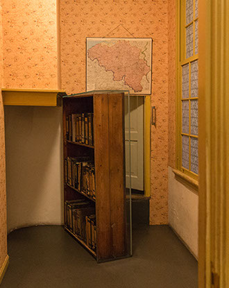 De gang met de boekenkast in het Anne Frank huis is voorzien van gereproduceerd behang